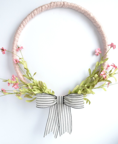round wreath with pink flowers and grey bow