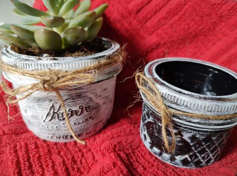 black and white jar with green plant