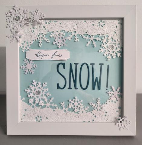 white frame with snowflakes and blue background