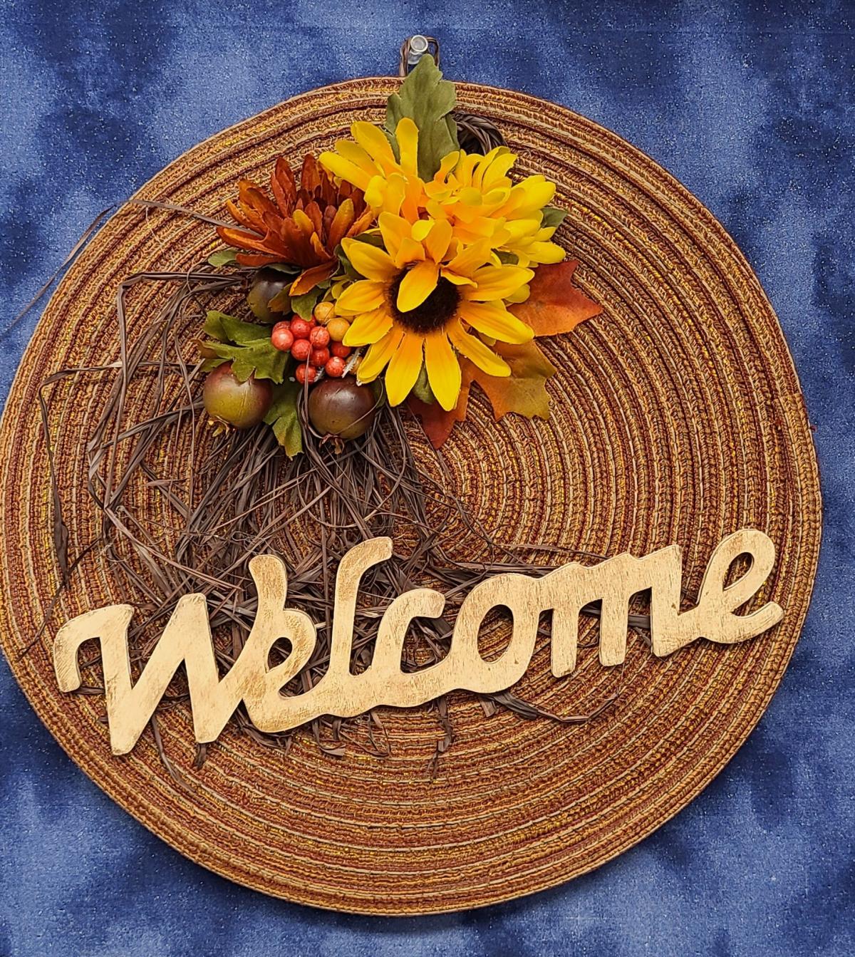 brown sign with yellow flowers