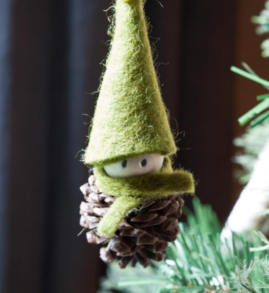 brown pinecone with face on wooden bead with green hat